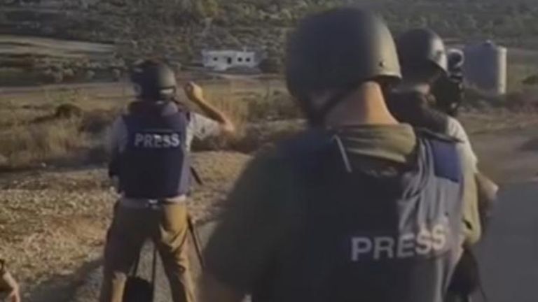 An image of journalists on a hill before they got hit 