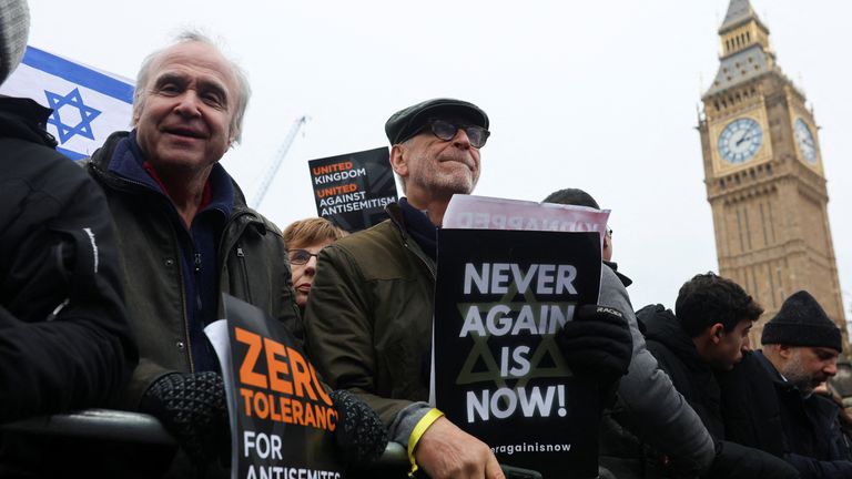 Demonstrators hold placards at a march in London against antisemitism, 26 November. Pic: Reuters