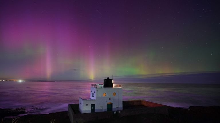 The aurora borealis, also known as the northern lights, appears over Bamburgh Lighthouse, in Northumberland on the North East coast of England. The aurora could be seen across the UK on Sunday. Picture date: Sunday November 5, 2023.
