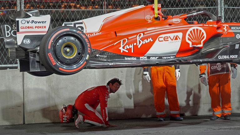 Ferrari driver Carlos Sainz, of Spain, looks at the bottom of his car after running over a manhole cover during the first practice session for the Formula One Las Vegas
Pic:AP