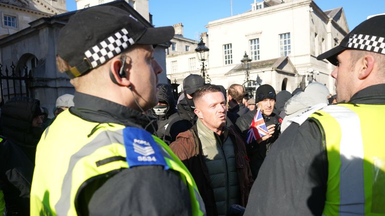 Tommy Robinson speaks to police officers as he arrives at the Cenotaph in Whitehall