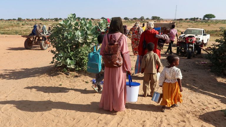 Women look at the border, hoping that their relatives reach Chad to escape death as they wait for them in Chad, November 7, 2023. REUTERS/El Tayeb Siddig