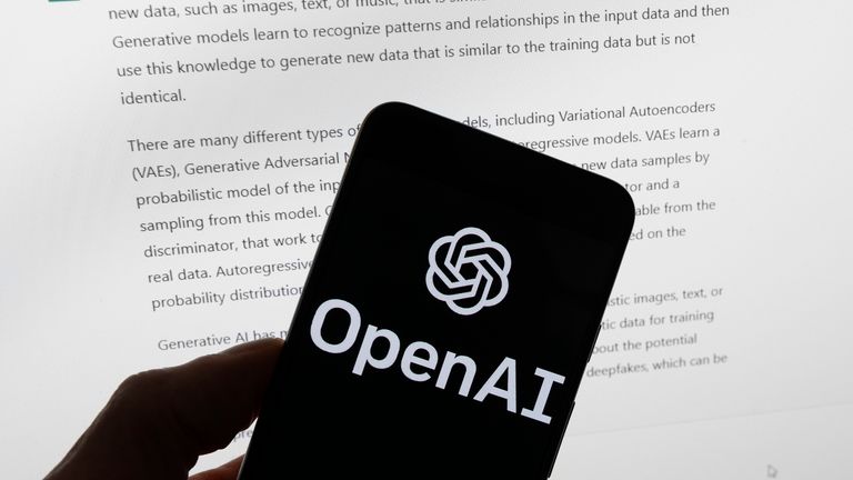 FILE - The OpenAI logo is seen on a mobile phone in front of a computer screen displaying output from ChatGPT, March 21, 2023, in Boston. Several news organizations, writers and photographers groups are seeking regulations to govern the fast-moving artificial intelligence technology that threatens upheavals for their businesses. In an open letter sent on Wednesday, Aug. 9, 2023, outlined priorities for setting rules on the technology, which is developing faster than regulators can keep up with. 