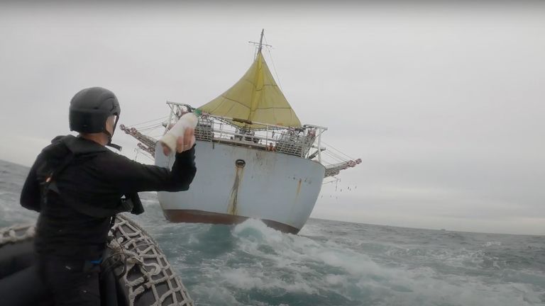 Reporter Ian Urbina throws a bottle with interview questions inside at Chinese squid boat. Pic: The Outlaw Ocean Project/James Glancy