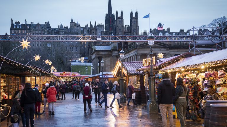 Shoppers at the Christmas Market on Edinburgh&#39;s Princes Street during New Year&#39;s Eve. Picture date: Friday December 31, 2021.