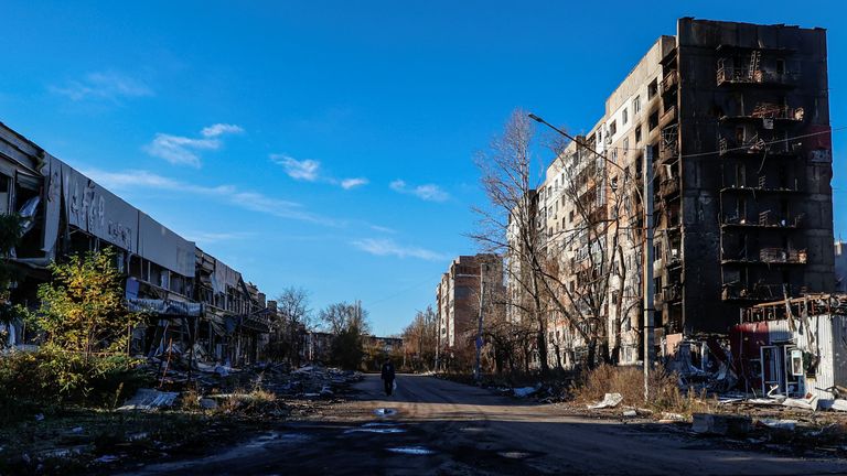A local resident walks next to residential buildings heavily damaged by permanent Russian military strikes in the front line town of Avdiivka, amid Russia&#39;s attack on Ukraine, in Donetsk region, Ukraine November 8, 2023. Radio Free Europe/Radio Liberty/Serhii Nuzhnenko via REUTERS