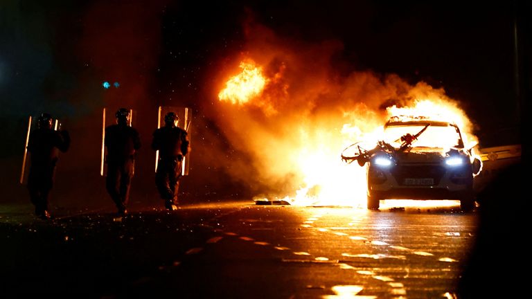A police car has been set on fire during the disorder 