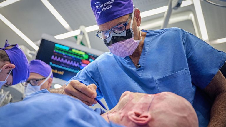 Dr Eduardo Rodriguez prepares Aaron James for the surgery