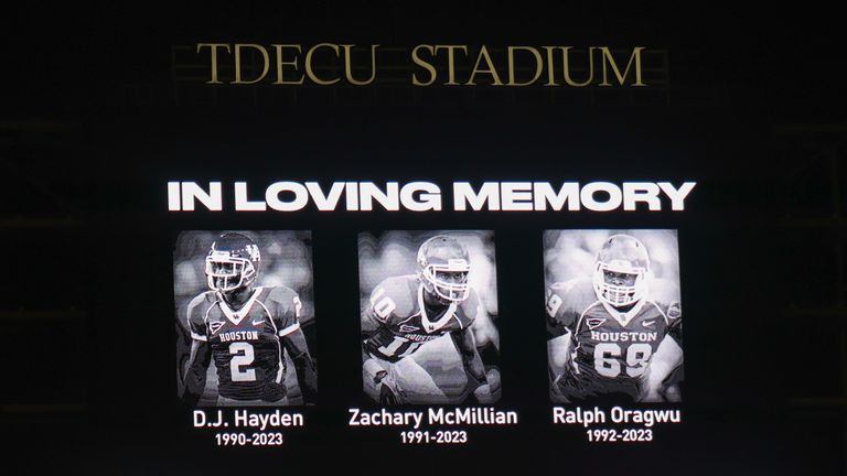 Fans stand for a moment of silence for the former Houston Cougars football players, D.J. Hayden, Zachary McMillian, and Ralph Oragwu who were killed in an automobile accident in Houston this morning of November 11,