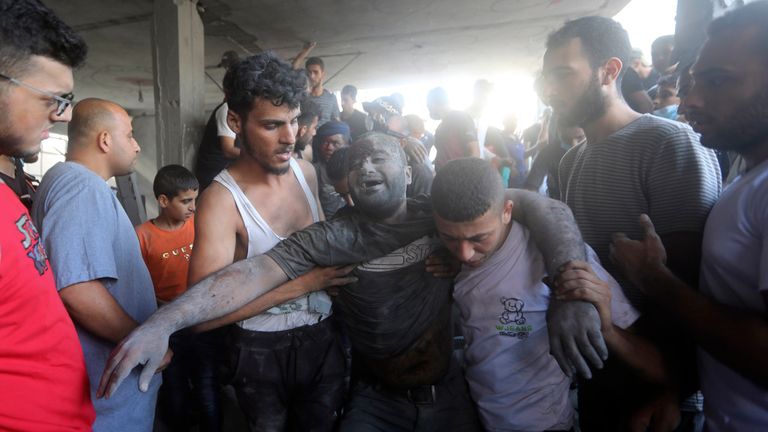 A Palestinian man reacts after being rescued from under the rubble in Bureij refugee camp. Pic: AP