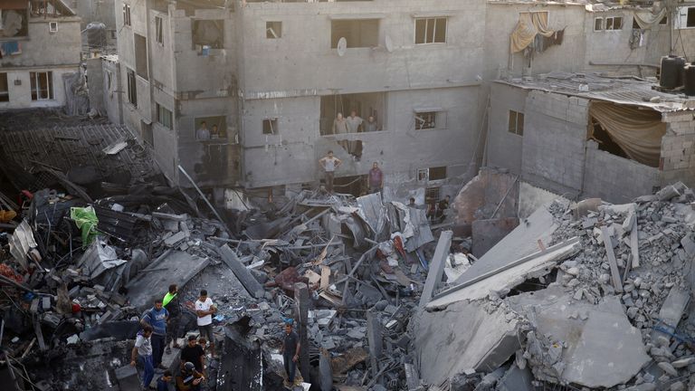 Palestinians search for casualties at the site of a blast at Maghazi refugee camp