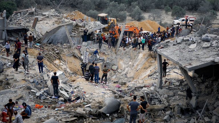 Palestinians at the site of an Israeli strike in  the southern Gaza Strip on 12 November 2023