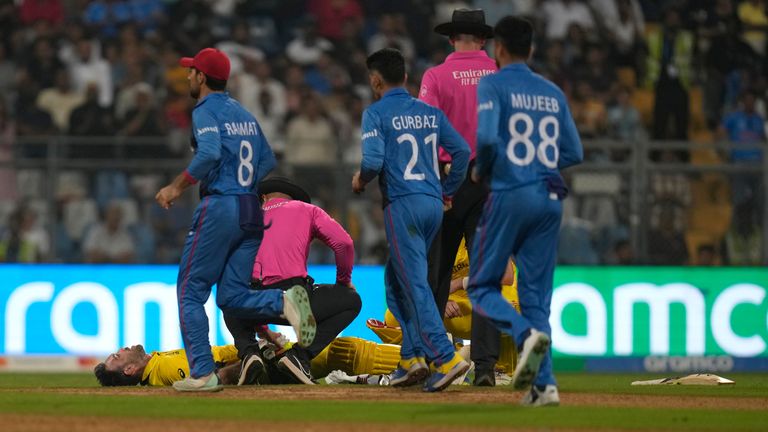 Australia&#39;s Glenn Maxwell lies on the ground as he struggles due to cramps during the ICC Men&#39;s Cricket World Cup match between Australia and Afghanistan in Mumbai, India, Tuesday, Nov. 7, 2023. (AP Photo/Rajanish Kakade)