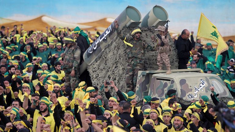 FILE - In this Oct. 27, 2015 file photograph, Hezbollah fighters stand atop a truck mounted with mock rockets as supporters chant slogans during a rally to mark the 13th day of the Shiite mourning period of Muharram, in Nabatiyeh, Lebanon. Iran's 1979 Islamic Revolution initially inspired both Islamic militants and Islamists across the Mideast. They saw the revolution as the starting gun in a competition to push out the strongman Arab nationalism that had taken hold across the Middle East. Howev