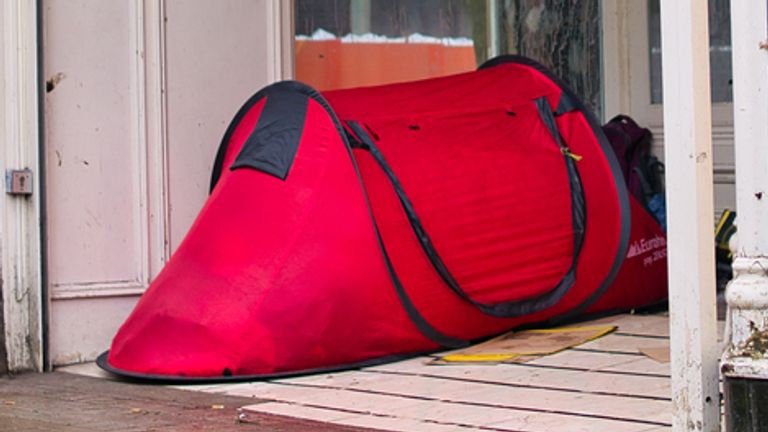 Tent pitched in the doorway of an empty shop