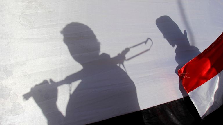 FILE - The shadow of Shiite rebels, known as Houthis, are cast on a large representation of the Yemeni flag as they attend a demonstration against an arms embargo imposed by the U.N. Security Council on Houthi leaders, in Sanaa, Yemen, on April 16, 2015. A delegation from Yemen&#39;s Houthi rebels have flown into Saudi Arabia for talks with the kingdom on potentially ending the yearslong war tearing at the Arab world&#39;s poorest nation, officials say. Pic: AP
