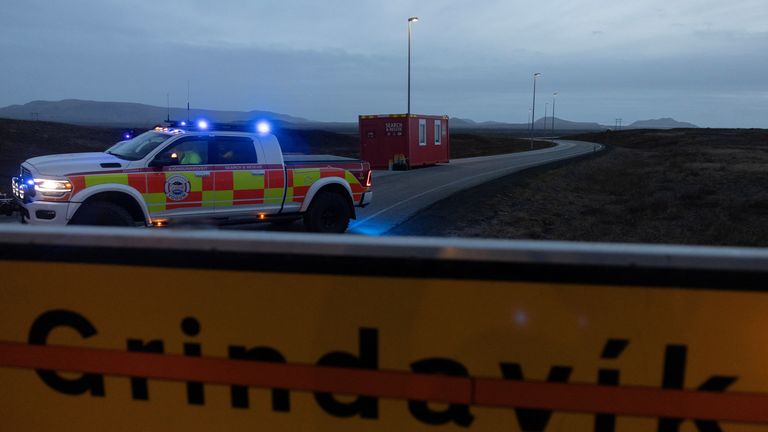 Police blocks a road leading to the village of Grindavik, which was evacuated due to volcanic activity