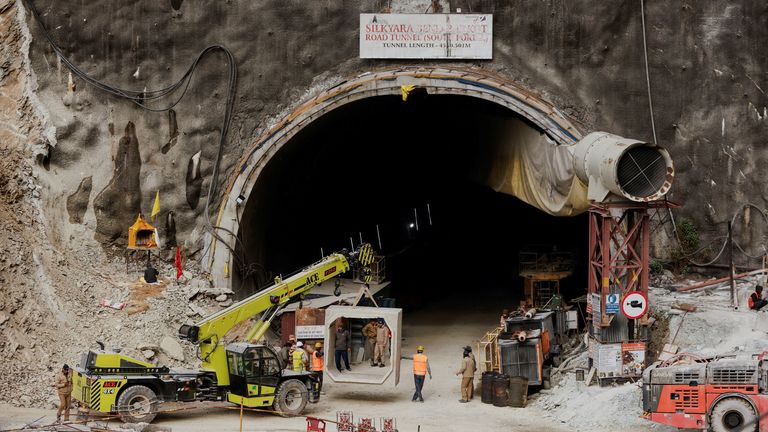 A concrete block is carried into the tunnel where rescue operations are underway to rescue trapped workers