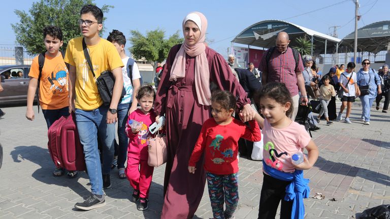 Palestinians cross to the Egyptian side of the border crossing with the Gaza Strip Wednesday, Nov. 1, 2023. in Rafah Wednesday, Nov. 1, 2023. (AP Photo/Hatem Ali)