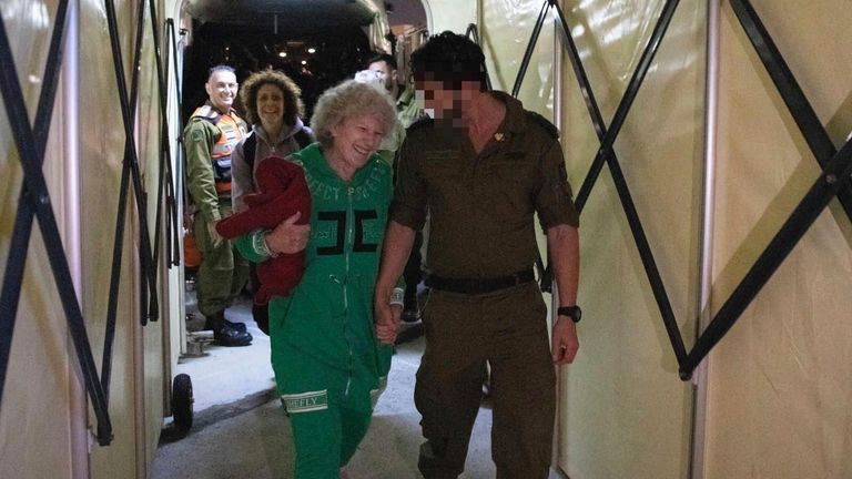 Ruth Munder, a released Israeli hostage, walks with an Israeli soldier shortly after her arrival in Israel on Friday, Nov. 24, 2023. Pic: AP