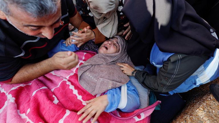 A Palestinian woman from the Abu Hattab family mourns her husband, amid the ongoing conflict between Israel and Palestinian Islamist group Hamas, in Khan Younis in the southern Gaza Strip, November 3, 2023. REUTERS/Mohammed Salem
