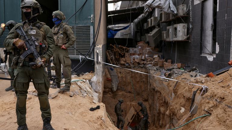 Israeli soldiers stand near the opening to a tunnel at al Shifa hospital compound in Gaza City