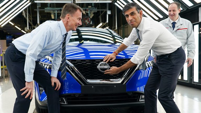 Prime Minister Rishi Sunak (centre right) and Chancellor of the Exchequer Jeremy Hunt attach a Nissan badge to a car during a visit to the Nissan car plant in Sunderland. The Government has confirmed Nissan will produce two new electric vehicle models at its Sunderland plant, supporting thousands of jobs in the UK. The Japanese carmaker&#39;s new electric Qashqai and Juke models will be manufactured at the site. Picture date: Friday November 24, 2023.
