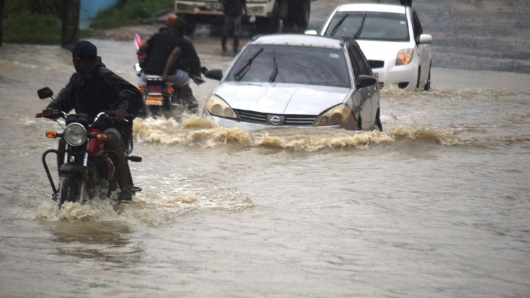 Motorists wade through a flooded road in Mombasa town after a heavy downpour. Pic: AP