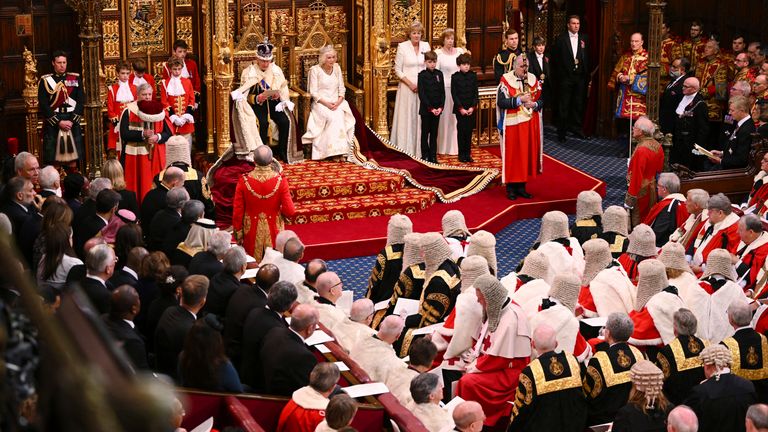  King Charles III delivers his speech as Queen Camilla sits next to him during the State Opening of Parliament at the Houses of Parliament, in London, Tuesday, Nov. 7, 2023. King Charles III read out a speech, written by Prime Minister Rishi Sunak...s government, outlining its legislative plans for the next year. (Leon Neal/Pool Photo via AP)