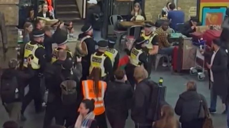 Police leading someone away during the protest 