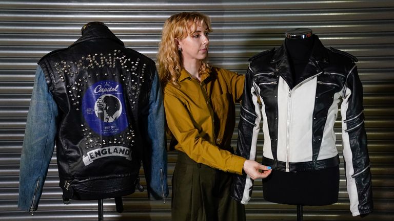 A Propstore employee adjusts Michael Jackson&#39;s custom-made leather jacket from a 1984 Pepsi New Generation commercial 