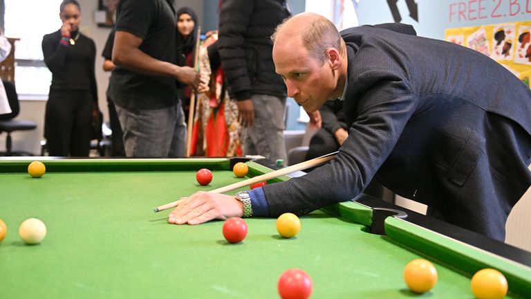 The Prince of Wales plays pool during his visit to The Hideaway Youth Project in Moss Side, Manchester 