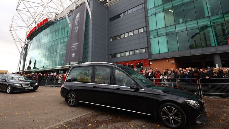 The funeral cortege of Bobby Charlton passes by Old Trafford