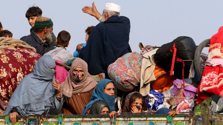 Afghan families onboard a truck head toward a border crossing point in Torkham, Pakistan, Tuesday, Oct. 31, 2023. Large numbers of Afghans crammed into trucks and buses in Pakistan, heading to the border to return home hours before the expiration of a Pakistani government deadline for those who are in the country illegally to leave or face deportation. (AP Photo/Muhammad Sajjad)
