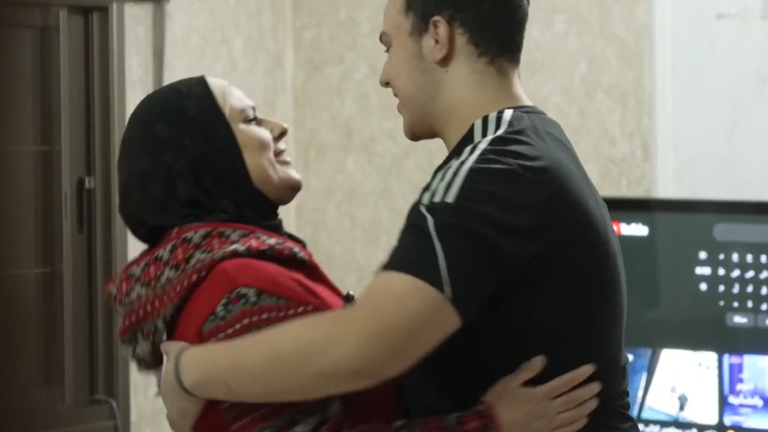 Ghannam Abu Ghannam hugs his mother