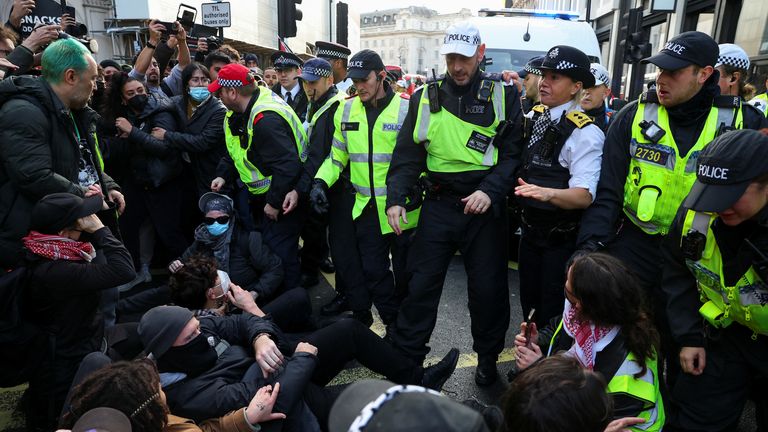 Demonstrators take part in a sit-down protest