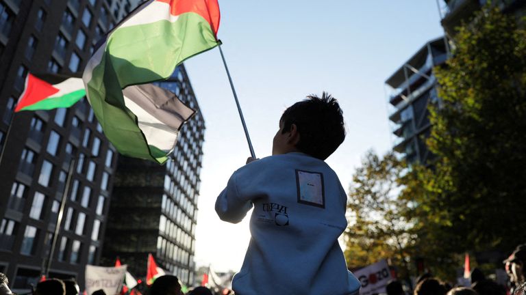 People march in a protest, in solidarity with Palestinians in Gaza, in London on 11 November