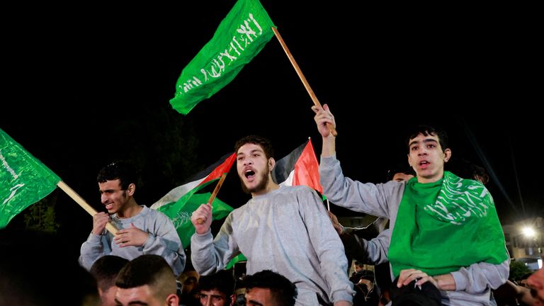 Released Palestinian prisoners wave flags after being  freed from an Israeli military prison