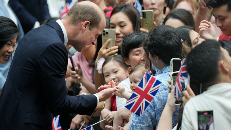 Prince William meets one of the youngest in the crowd, baby Albany Costa. Pic: AP