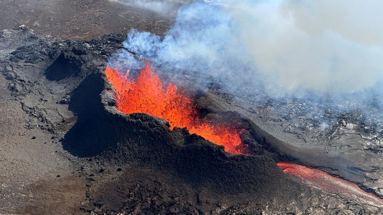 Lava spurts and flows after the eruption of a volcano in the Reykjanes Peninsula, Iceland, July 12