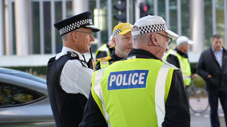 Sir Mark Rowley, left, talking to officers policing the protest