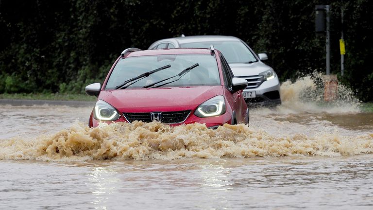 Vehicles are driven through a flooded road in Yapton, West Sussex, as Storm Ciaran brings high winds and heavy rain along the south coast of England. The Environment Agency has issued 54 warnings where flooding is expected, and an amber weather warning is in place with winds expected to reach 70mph to 80mph. Picture date: Thursday November 2, 2023. PA Photo. The UK saw one of the wettest Octobers on record as Storm Babet battered the country and now Storm Ciaran is due to bring "danger to life" amber weather warnings as it hits the UK. See PA story WEATHER Ciaran. Photo credit should read: Joe Sene/PA Wire