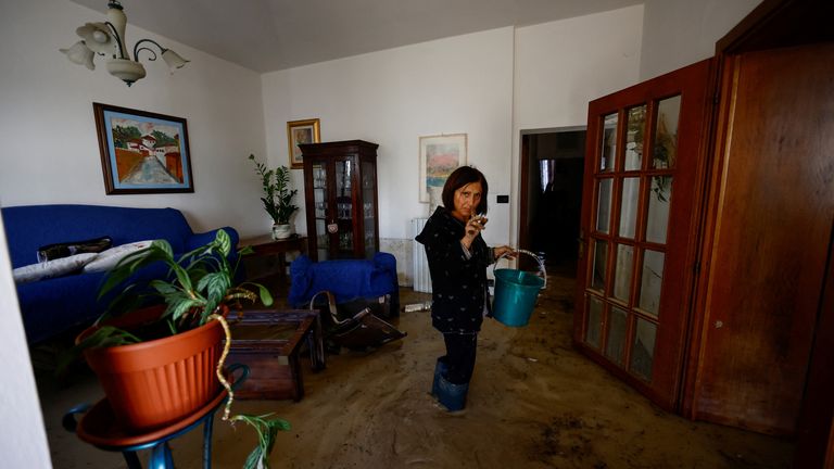 Enza Carfagno stands in her flooded apartment in the aftermath of Storm Ciaran, in Campi Bisenzio