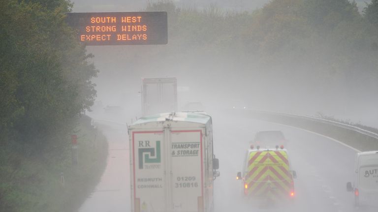 A weather warning sign alerts drivers travelling through water spray and winds on the M5 motorway