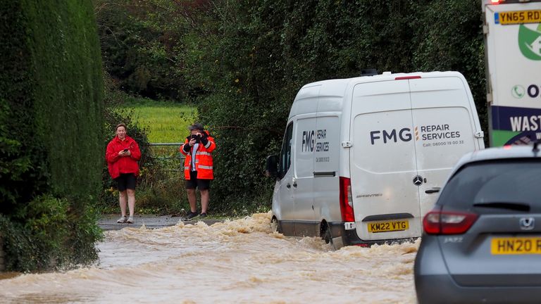 Vehicles are driven through a flooded road in Yapton, West Sussex, as Storm Ciaran brings high winds and heavy rain 