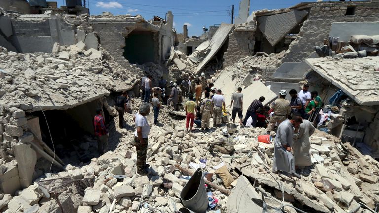 Civilians search for survivors at a site activists said was hit by barrel bombs