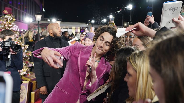 Timothee Chalamet takes selfies with fans as he arrives for the world premiere of Wonka at the Royal Festival Hall in London. Picture date: Tuesday November 28, 2023. PA Photo. See PA story SHOWBIZ Wonka. Photo credit should read: Ian West/PA Wire