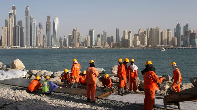 FILE - In this Tuesday, Sept. 22, 2015 file photo, with the Marina Waterfront skyline in the background, laborers work at a construction site at the Palm Jumeirah, in Dubai, United Arab Emirates. Human Rights Watch has released on Tuesday, Dec. 22, 2015 a set of guidelines it says construction companies working in the oil-rich Gulf Arab states should follow to ensure basic rights for migrant workers. Pic: AP