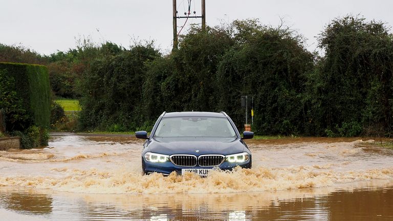 Vehicles are driven through a flooded road in Yapton, West Sussex, as Storm Ciaran brings high winds and heavy rain along the south coast of England. The Environment Agency has issued 54 warnings where flooding is expected, and an amber weather warning is in place with winds expected to reach 70mph to 80mph. Picture date: Thursday November 2, 2023.