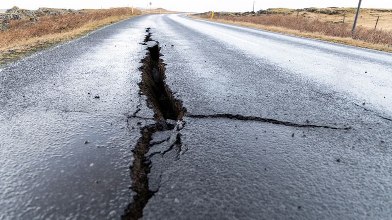 Cracks emerge on a road due to volcanic activity at the entrance to Grindavik